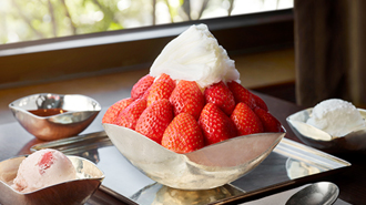 there is a Snowy strawberry bingsu in the silver bowl